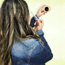 women applying makeup with chihuahua mirror on green background