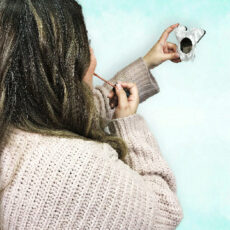 women applying lip makeup with schnauzer themed mirror