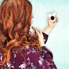 women applying lipstick with schnauzer mirror