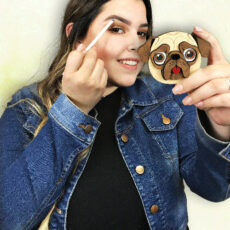 women applying eye makeup with chihuahua mirror