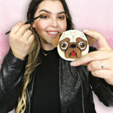 women applying makeup with pug themed mirror