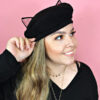 Woman wearing cat eared beret hat looking to side