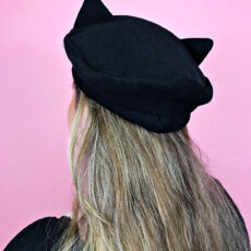 Woman wearing cat eared beret hat back view