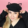 Woman wearing cat eared beret hat