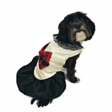 Side view of dog with dress featuring red tartan bow with black skirt