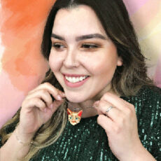 women smiling wearing cat necklace