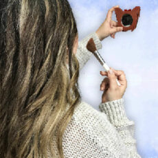 women applying makeup with yorkie mirror