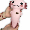 woman holding pink plush dog toy