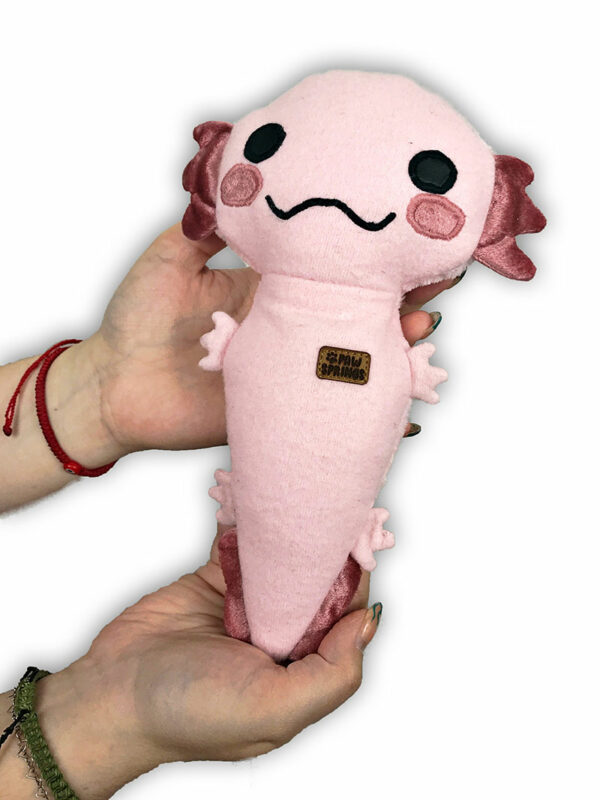 woman holding pink plush dog toy